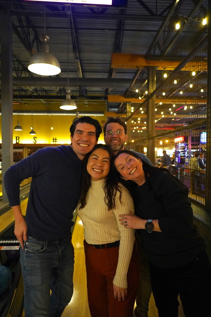 4 people taking a picture together.