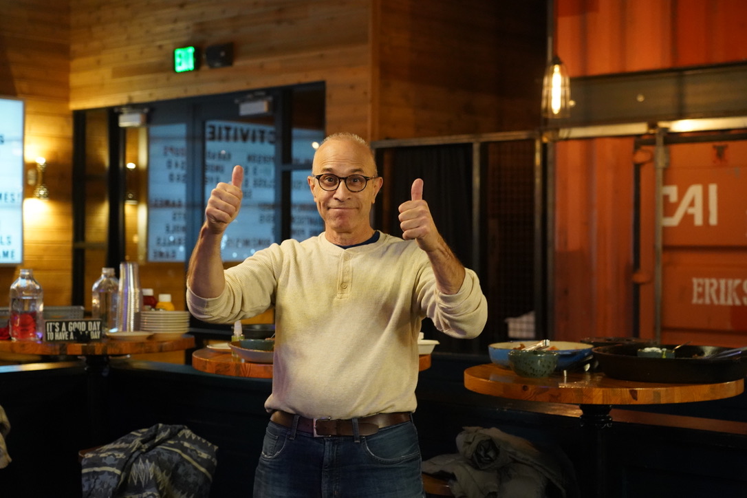 Person posing with two thumbs up.